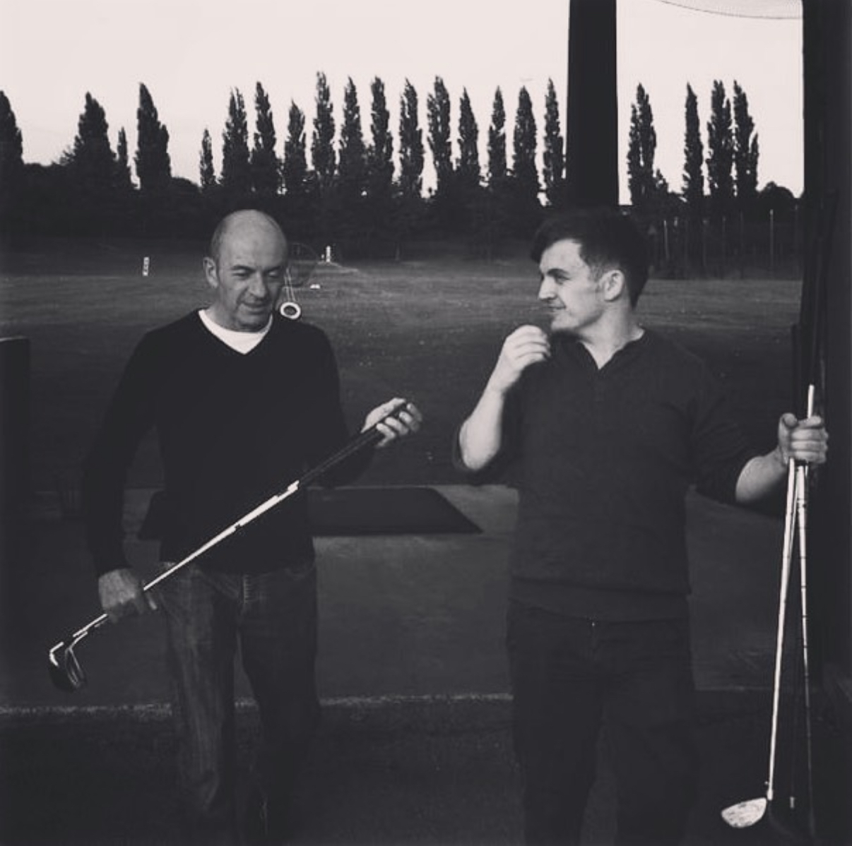 Jimmy and Antony at the driving range, sharing a moment between swings
